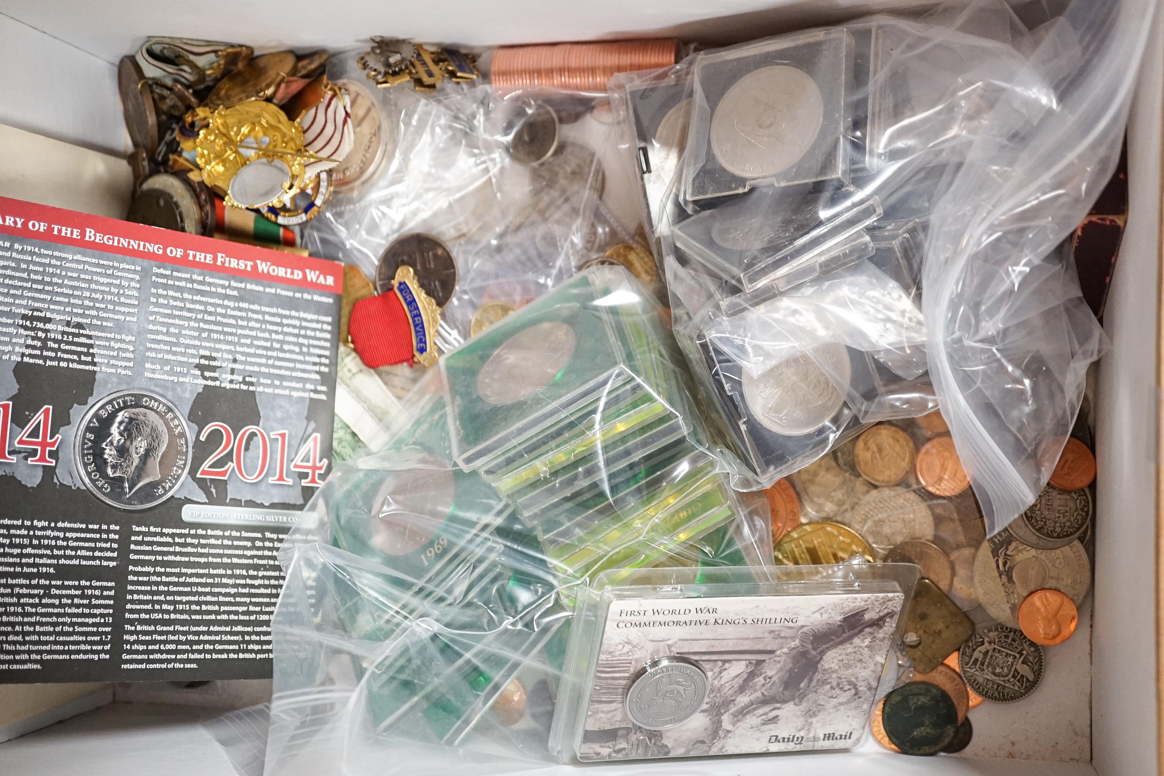 A collection of military badges and a collection of coins